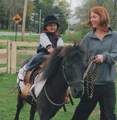 Boy riding a pony during lessons at Little Dude Ranch